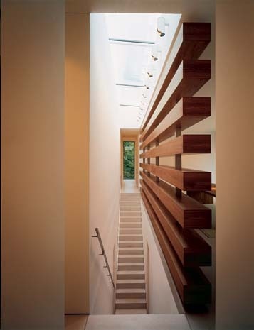At the heart of the house is a double staircase, day lit from above, with a timber screen to the entrance hall