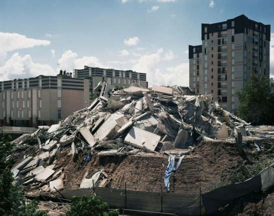 <i>Cairns</i> (251/261 Résidence Provence, Dammarie-lès-Lys, 1973–2008) 2008. <br /><i>Cairns</i> is the title of a series of photographs depicting the aftermath of the demolition of high-rise public housing in Glasgow and the Parisian suburbs. The visual language connects to that used by photographers of the Düsseldorf school, from Bernd and Hiller Becher to Andreas Gursky and Thomas Struth. The word “cairn” indicates “a pyramid of rough stones raised as a memorial”. Courtesy Cosmic Galerie (Bugada & Cargnel), Paris 