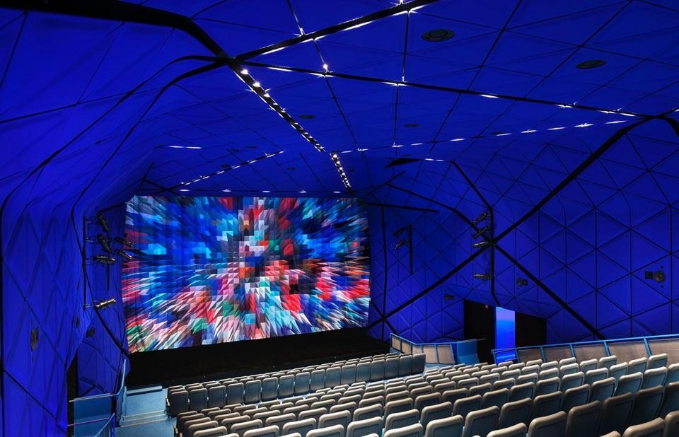 The 264-seat theater is a luminous cocoon whose walls and ceiling are wrapped in blue felt. ©Peter Aaron. Courtesy of Museum of the Moving Image