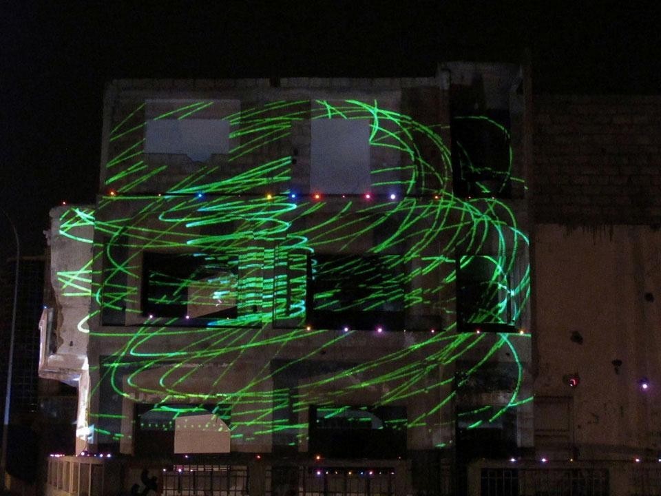 Laser images projected on Maison 46 in Zone A of Dakar. The building – abandoned for 10 years – is destined for demolition. The projections underline the decrepit state of the building and, with drawings and new images, prefigure its future.