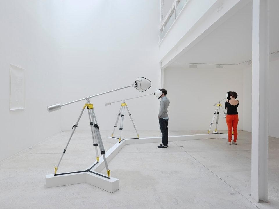 Didier Faustino, <i>Instrument for Blank Architecture</i> (aluminum, polyester resin, plastic foam, headphones and mp3 reader. 260 cm x 180 cm., 2010).  A cantilevered tripod generally used by land surveyors to document here becomes an instrument dedicated to the exploration of mental landscapes.
