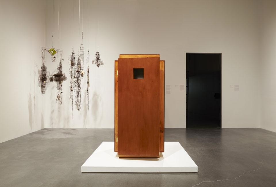 In the background, Emery Blagdon, <em>Untitled,</em> ca. 1955—86. In the foreground, <em>Orgone Energy Accumulator</em>, 2012, invented by Wilhelm Reich in 1940