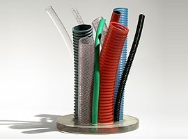 Plastic and rubber cables of various sizes go to make up a vase for flowers. Design by Thais Stoklos and Leonardo Ceolin, 2002