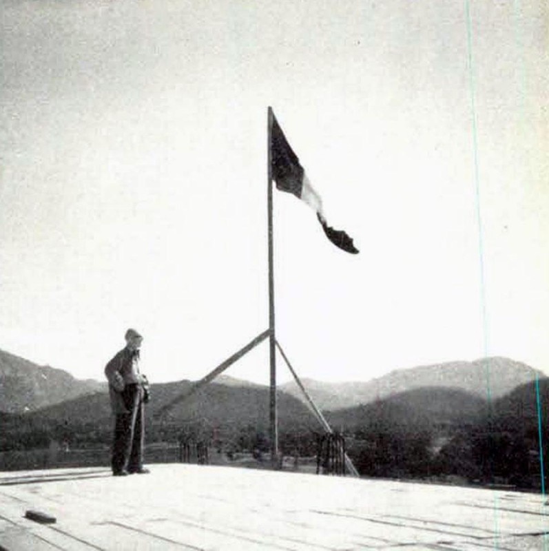 Le Corbusier and the flag raised above the "Unité d'habitation," October 6, 1949.