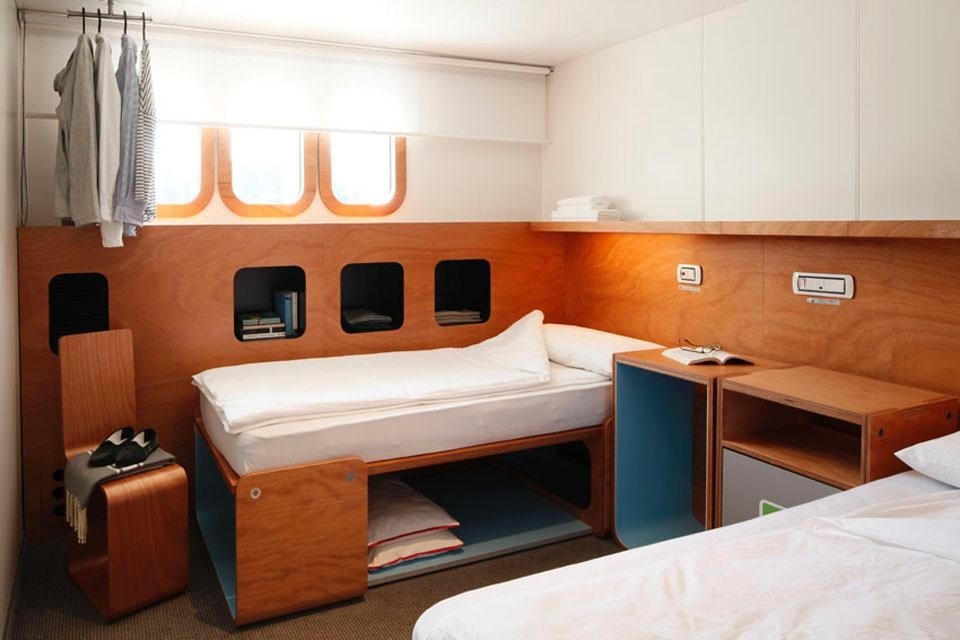 Cabin interior with single bed configuration.