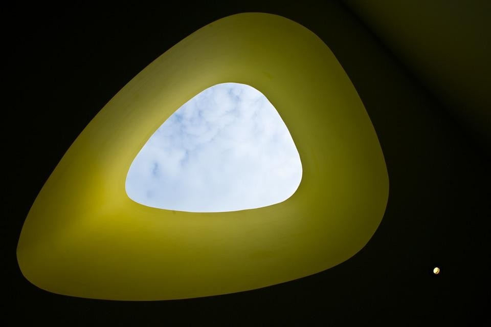 The building is topped with a an irregular-shaped yellow rooflight that provides a lively aspect for those working in the surrounding higher buildings