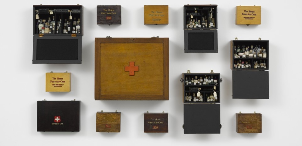 Susan Hiller, <i>Emergency Case: Homage to Joseph Beuys</i>, 2012. 13 wooden felt-lined first aid cabinets, containing bottles of holy water and vintage first aid supplies, 98 x 117.5 cm © Susan Hiller; Courtesy Lisson Gallery. Photograph: Jack Hems