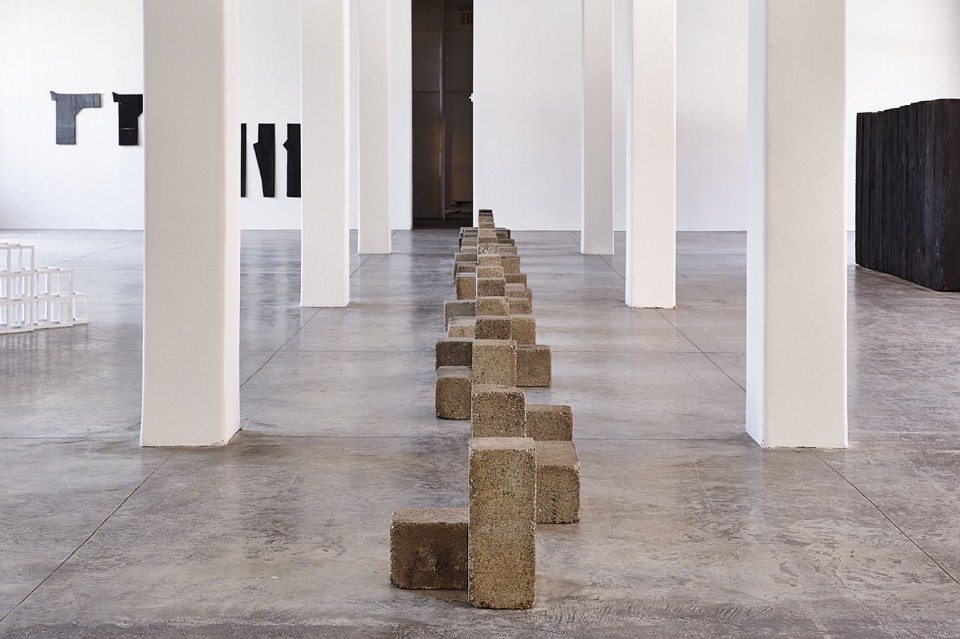 Installation view of Uncarved Blocks by Carl Andre in FORTY. Image courtesy of MoMA PS1. Photo by Pete Deevakul.