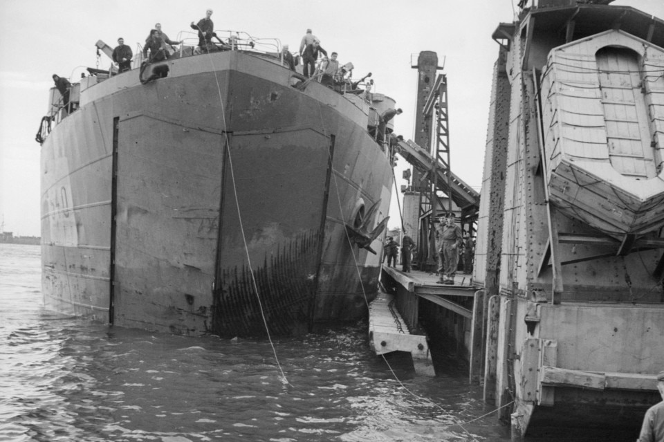 Ship docked at Mulberry harbour, 1944. © Imperial War Museum