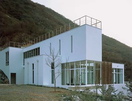 <b>Kanika R’Kul</b>. The Shared House has the white walls and severe geometry of the Great Wall Commune’s most obvious precedent, the Weissenhof Siedlung
