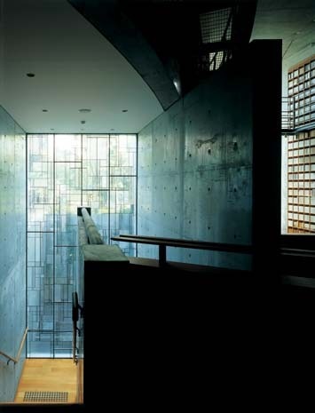 Ando allows sunlight to filter into the interior, spanned by flying bridges worthy of a Piranesi etching