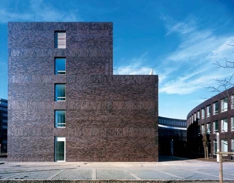 Vertical brick courses mark floor levels