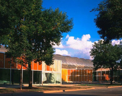 The building is one storey high, surrounded by transparent glass walls
