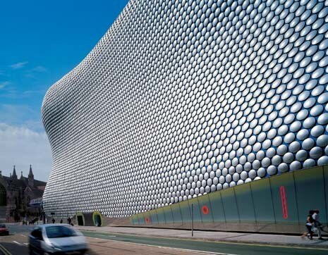 The lack of any conventional architectural elements makes it hard to read the scale of the building. 
In fact it is a relatively modest five floors high