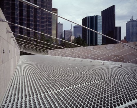 An innovative, cast-aluminum sunscreen device will float above the glass and allow controlled natural light to filter into the galleries, eliminating the need for artificial illumination much of the time
