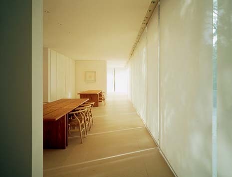 Kitchen and living rooms are on the lower level with a broad terrace. Bedrooms float above them