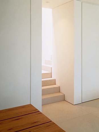 A right-angle turn at the foot of the stairs, left, opens into the kitchen and dining room