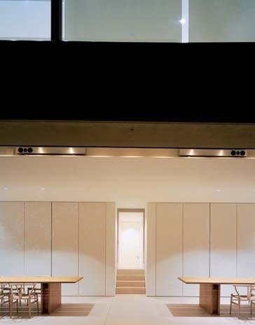 The dining room is positioned at the foot of the stairs, offering the kitchen a more private position, out of sight to the left