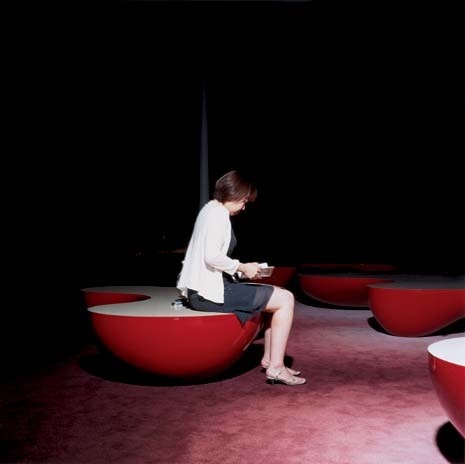 The bubble-like FRP
benches, scattered around the Theatre Park, appear to bleed light out into
the surrounding carpet
