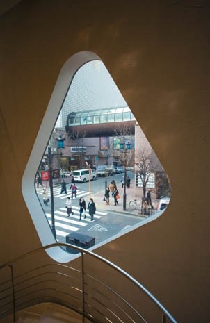 The view through one of the builder-shaped windows onto Marronier-dori Street and Namiki-dori Street. Altogether Toyo Ito makes use of 163 such glazed apertures in his design for the facade