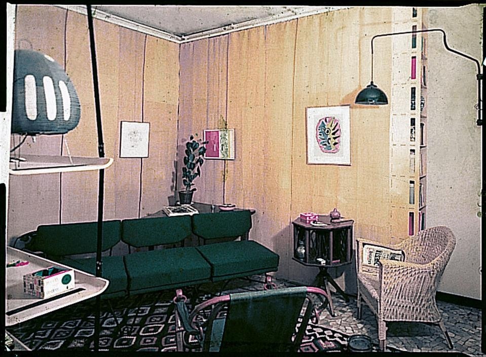 The living
room; the passage from
the dining room to the
entry zone; the bed
with brass legs and
headboard hung from
adjustable leather
straps
