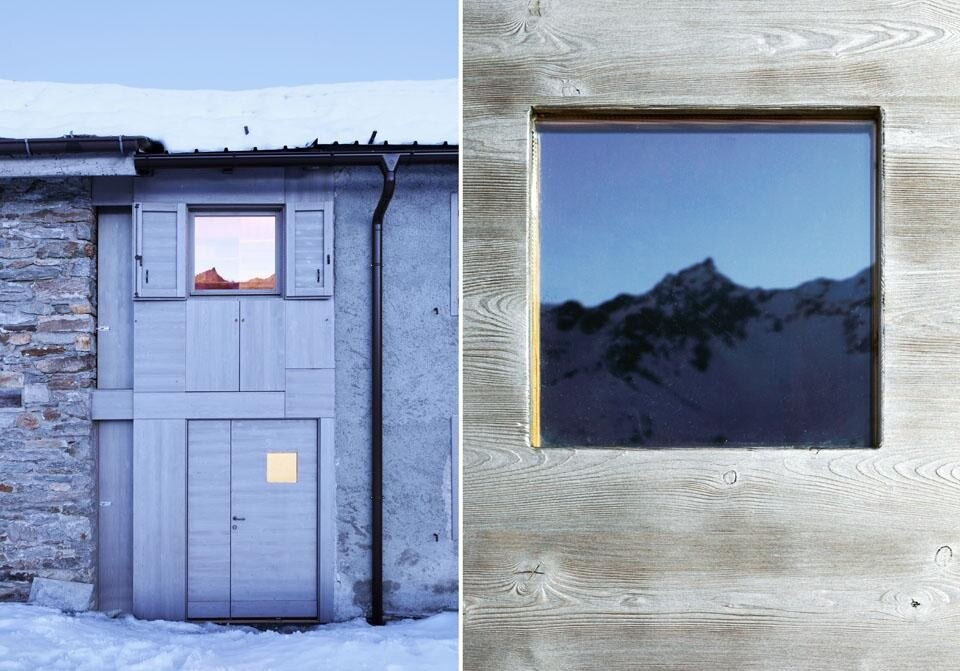 With the sunlight reflecting off the mirror-like wood, the micro-cabin is visible from a distance.