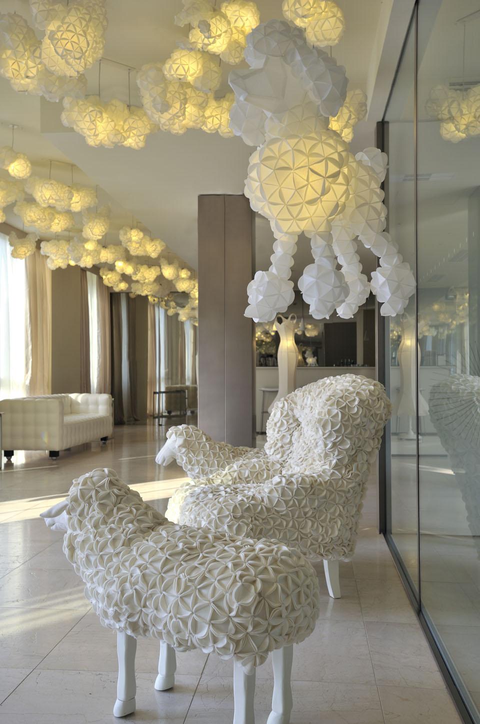 Sheep sculptures and poodle-shaped lamps welcome guests at the entrance.