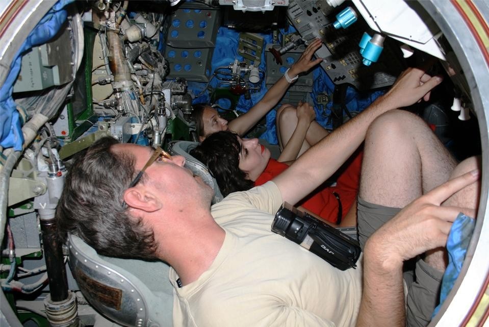 Playing with Michael Madsen and Regina Peldszus in the Soyuz capsule. Photograph by Nelly Ben Hayoun.