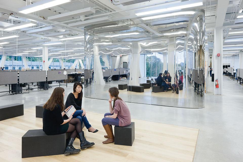 On the first floor, a mirror-surfaced
closet separates
the tiered auditorium from
the student areas.