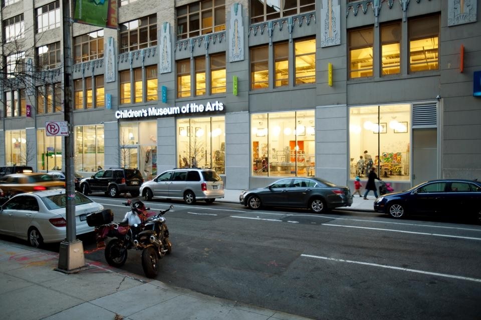 The entrance of the Children's Museum of the Arts, which connects to the surrounding neighborhood with wide windows