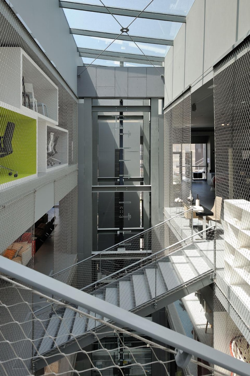 The central lobby showing the stairs linking the staggered floors. Photo by E. Saillet