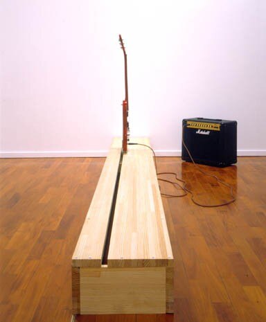 "Ohm", guitar on a wooden footboard having a electric mechanism and amplifier, 2002
