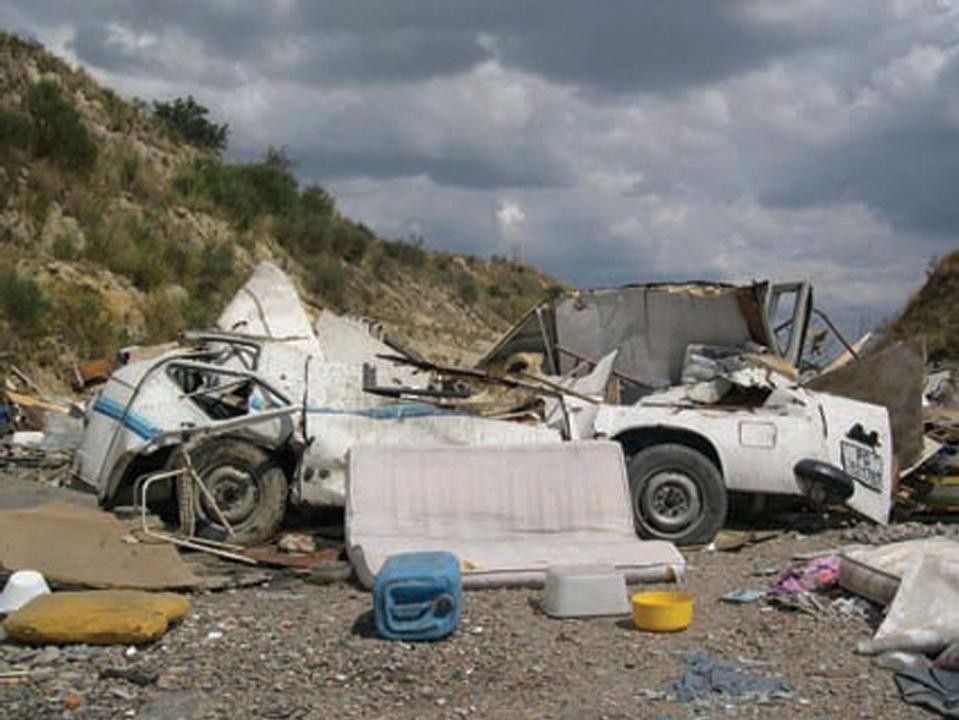 Muratella, Roma, Italy. The inhabitants of the Muratella settlement were evicted hastily and violently by the police in 2004. here buldozers in action are getting rid of the evidence, pushing the trash behind the hill so the passer by will no longer notice the Roma settlement