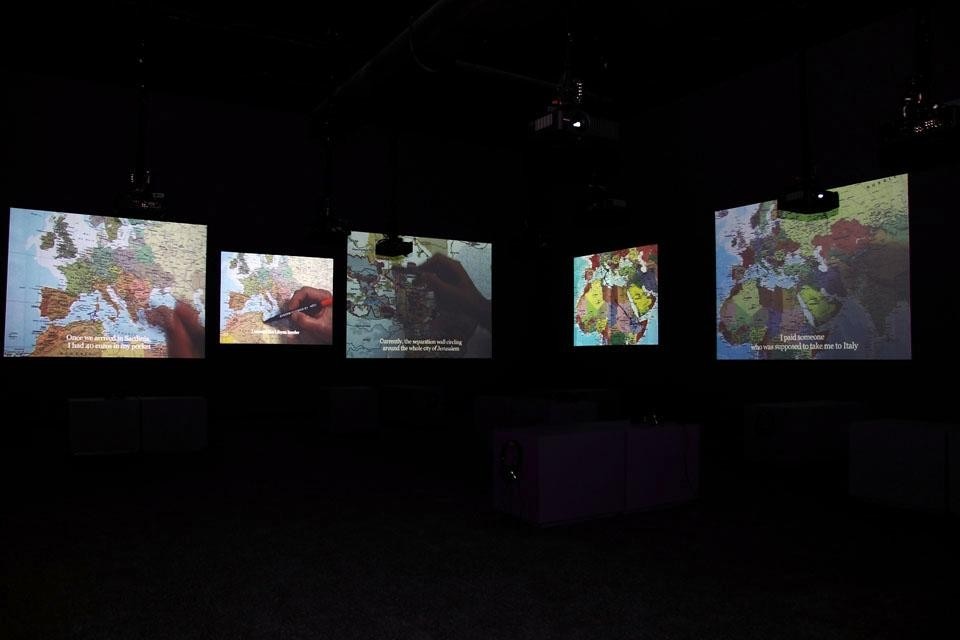 Bouchra Khalili, <i>The Mapping Journey Project</i>, 2008–2011, 8 videos and printed map mounted on the wall. Bouchra Khalili, <i>The Mapping Journey Project</i>, 2008–2011, 8 videos and printed map mounted on the wall.