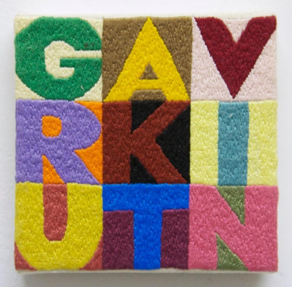 <em>Order & Disorder</em> (2012) is a square composed of sixty-four individual nine by nine grids, each one an embroidered anagram of Turk's name