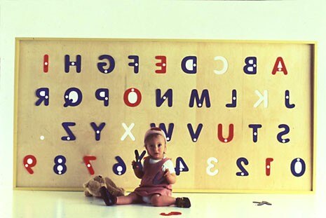 Alphabetti Biscotti, design Andrew Stafford. Wall-mounted shelf which has removable plastic stencils