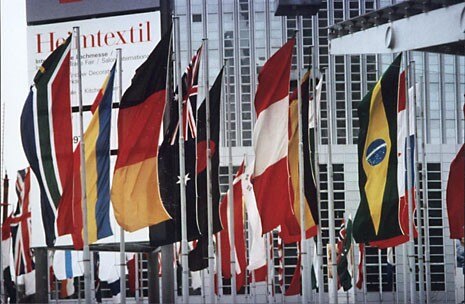 67 national flags flutter outside the trade fair, proclaiming the diversity of nations represented