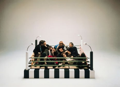 The way they were. 
From the left: Aldo Cibic, Andrea Branzi, Michele De Lucchi, Marco Zanini, Nathalie Du Pasquier, George Sowden, Matteo Thun, Martine Bedin and Ettore Sottsass, photographed by Studio Azzurro in Masanori Umeda’s boxing ring bed from the first Memphis collection in 1981





