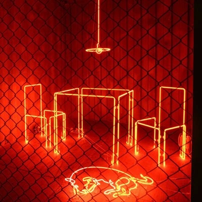 An enigmatic installation by Takehiro Ando using red neon light to outline three-dimensional objects in container 31