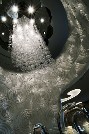 A chandelier made of hundreds of hand-blown Murano glass balls hangs in the round opening of the rotunda on the second floor of the boutique. The lighting for the Salon was created with the collaboration of Hervé Descottes