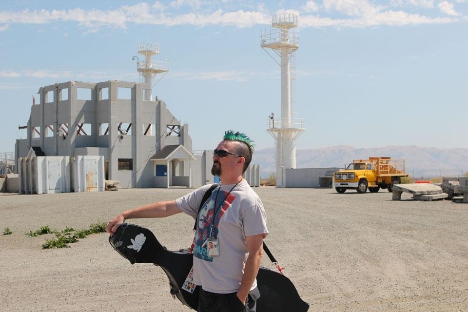 Matthew Linton, International Space Orchestra cello player, portrayed at the NASA Ames Rescue Site. Photo by Nelly Ben Hayoun