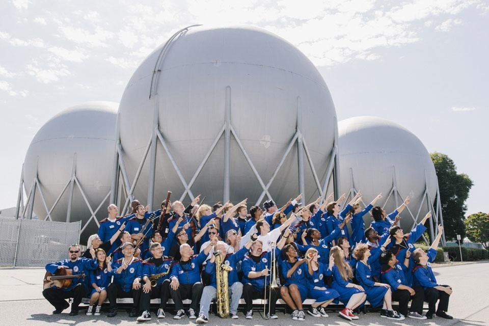 Top: Nelly Ben Hayoun in front of largest windtunnel in the world, at the NASA Ames Research Center during filming for <em>The International Space Orchestra</em>. Above: The International Space Orchestra