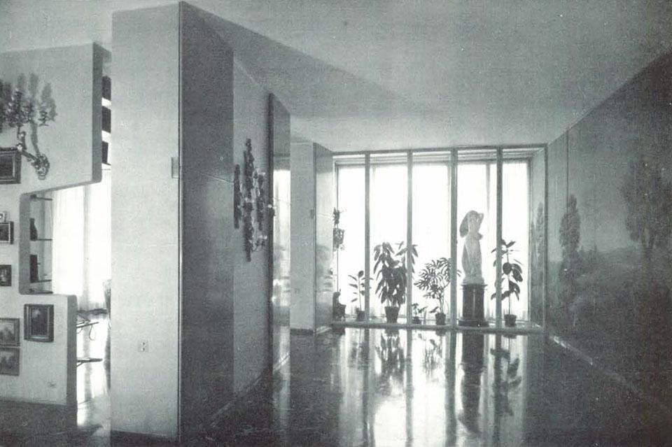 View of the atrium. Above: view from the bedroom. The building is surrounded by a park