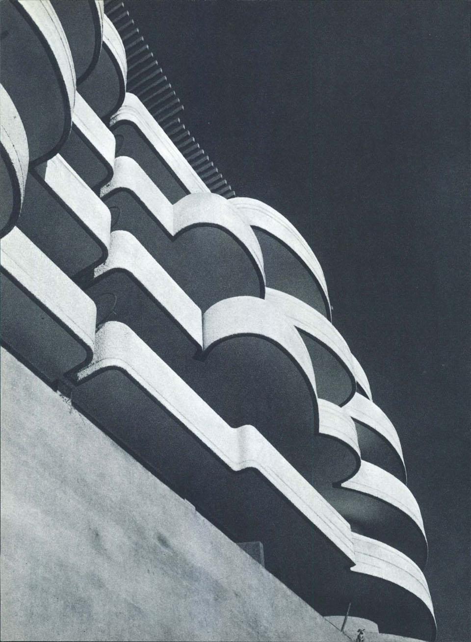 The terraces, horizontal overlapping tub-like forms, visually eliminate the entire vertical wall. The building’s perimeter, which is set back, disappears, revealing  the interior reaching out towards  the exterior.  There is no longer a facade but a continuous curving surface born from free design and not from fixed rules or structural needs