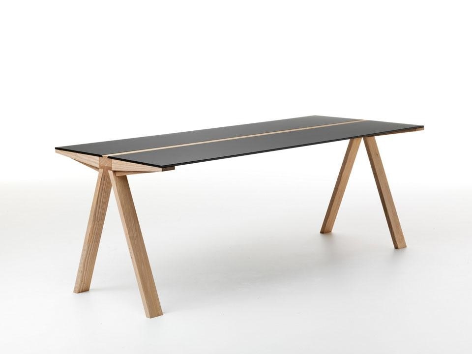 The table is available with glass or wooden tops