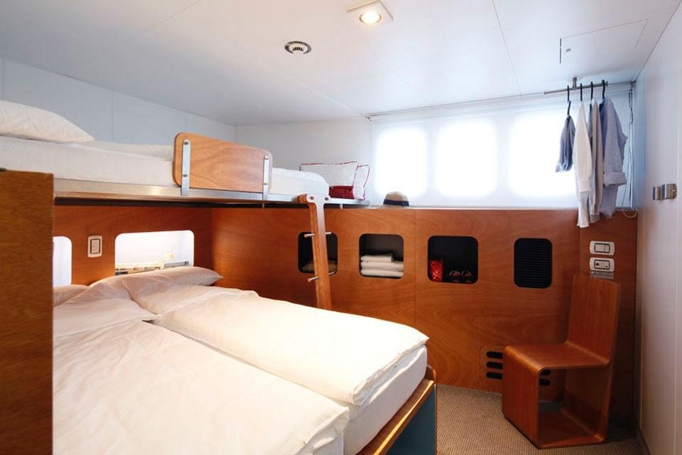 Cabin interior with double bed configuration.