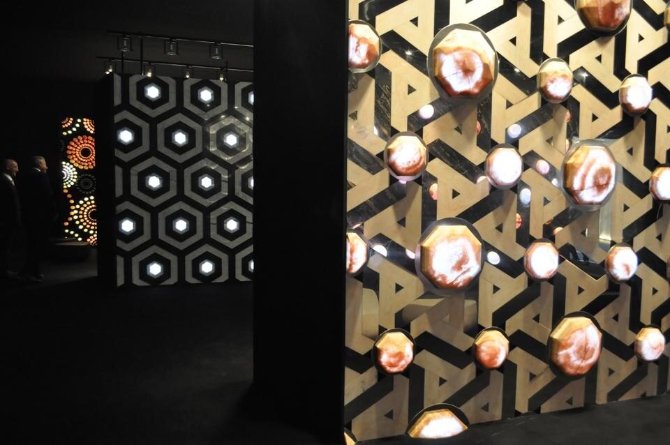 Foreground: Fleur du Desert: pink marble stars are mixed with chrome steel inserts and are positioned individually on a steel ferrule. Background: Hexagone.
A working process with a hexagonal geometric motif, in bas-relief in the tones of white and green marble. 