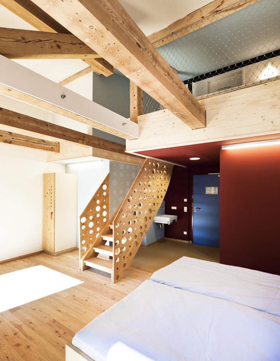 Unused space under the attic becomes a mezzanine level with additional beds
open to the spaces below