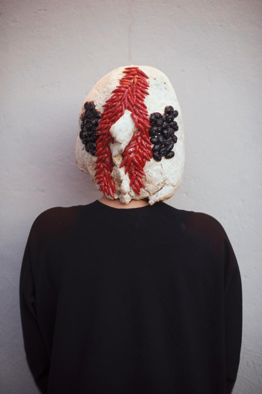 <i>Un amico per cena</i> by Sara Ricciardi is inspired by the cannibalism of the indigenous tribes and becomes a metaphor for human relationships. Sara has given shape to a metaphoric concept with the creation of masks born from bread and edible icing
