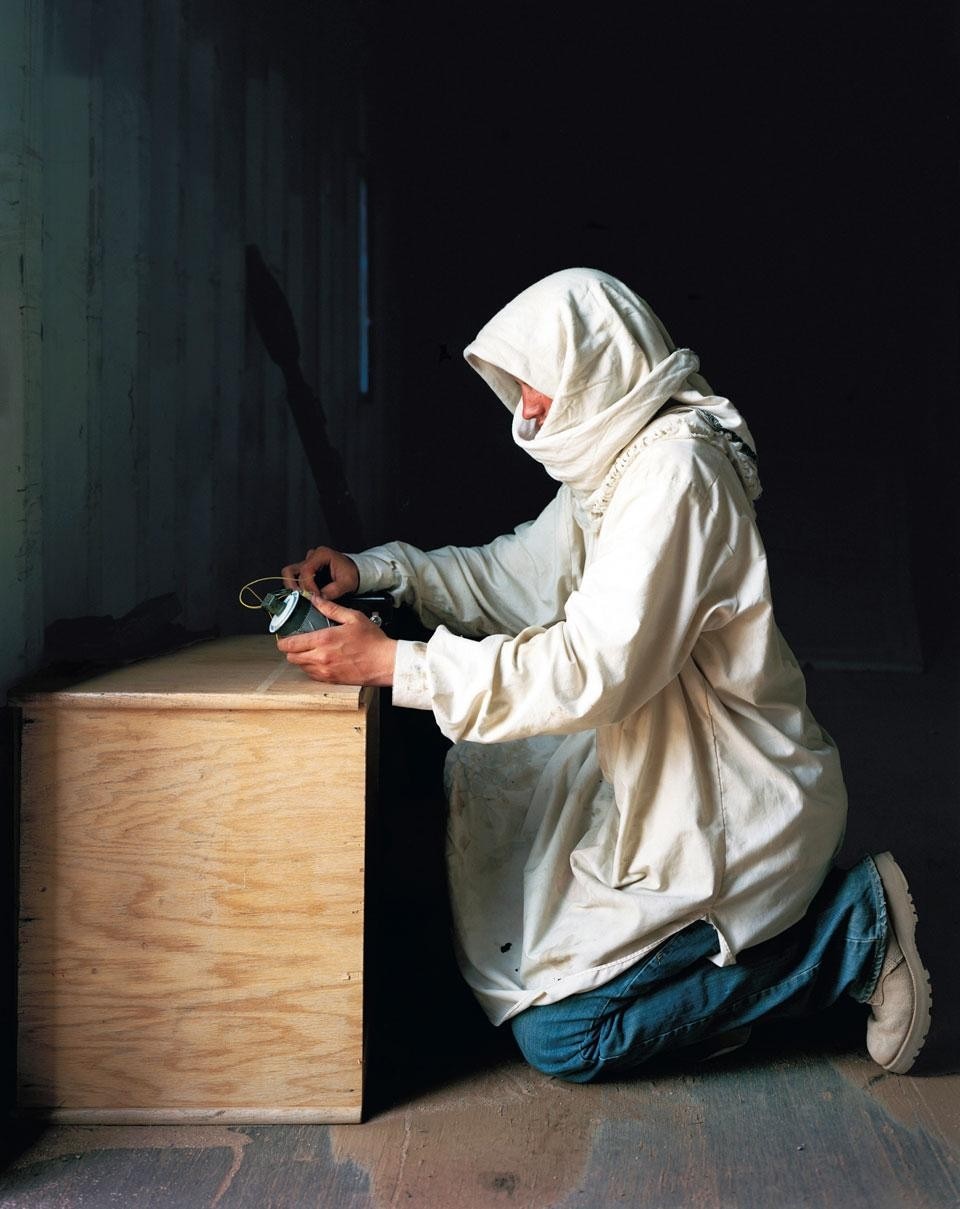 Army Specialist Gary McCorkle playing the role of
“Jibril Ihsan Hamal,” a key member of the leading
terrorist group in town, with an IED, Medina Wasl
Village, National Training Center, Fort Irwin,
CA, 2009, 40 x 30 in.
Courtesy of the artist & Carroll
and Sons, Boston
